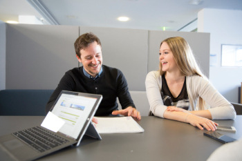 Two students reviewing visa documentation.